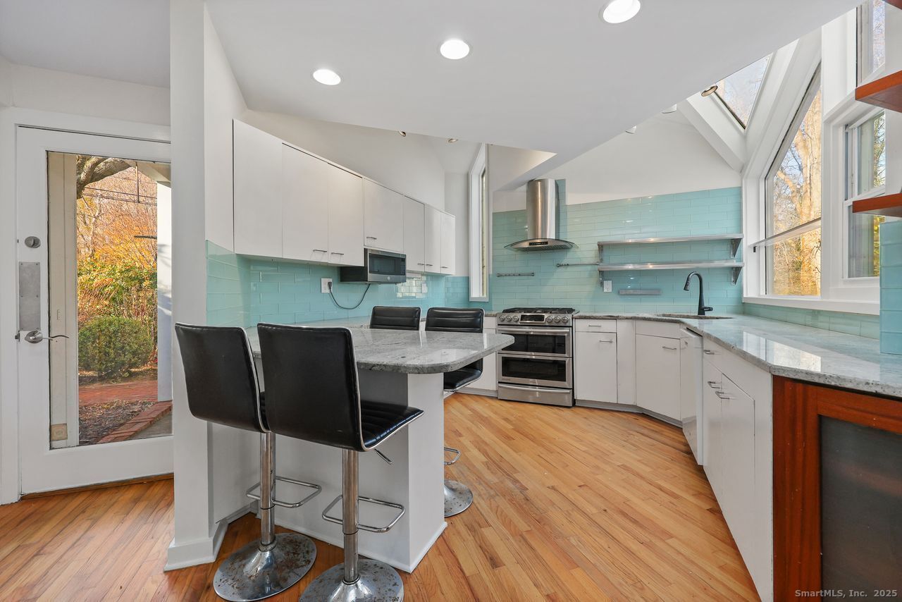 38 Chester Road Easton, CT 06612 - Photo 7 of 36 a kitchen with stainless steel appliances granite countertop a stove top oven a sink dishwasher and white cabinets with wooden floor