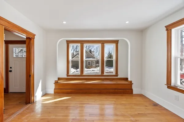 a view of a room with wooden floor and a window
