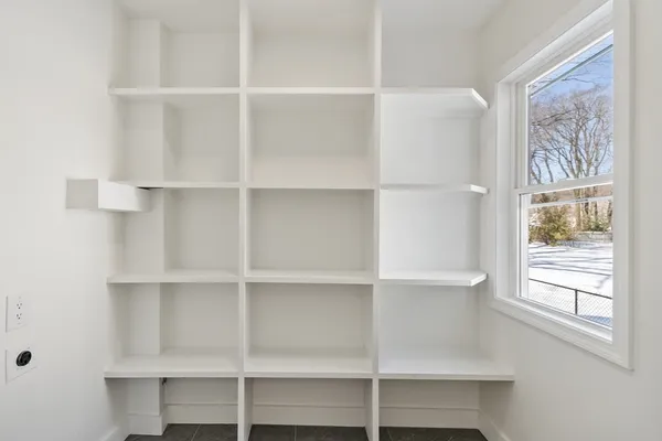 a view of a room with shelves on the wall