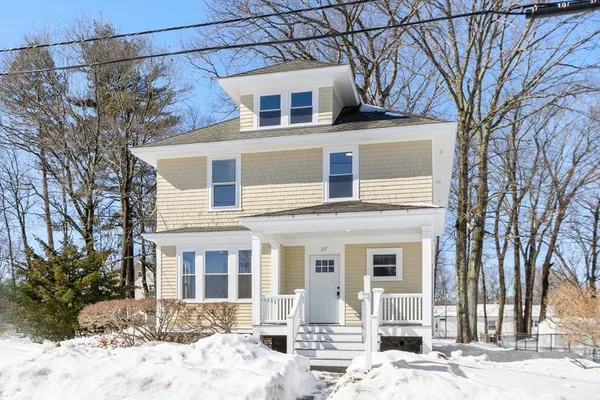 a view of a house with snow on the side of the road