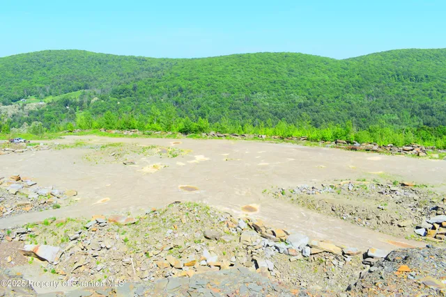a view of a road with a field