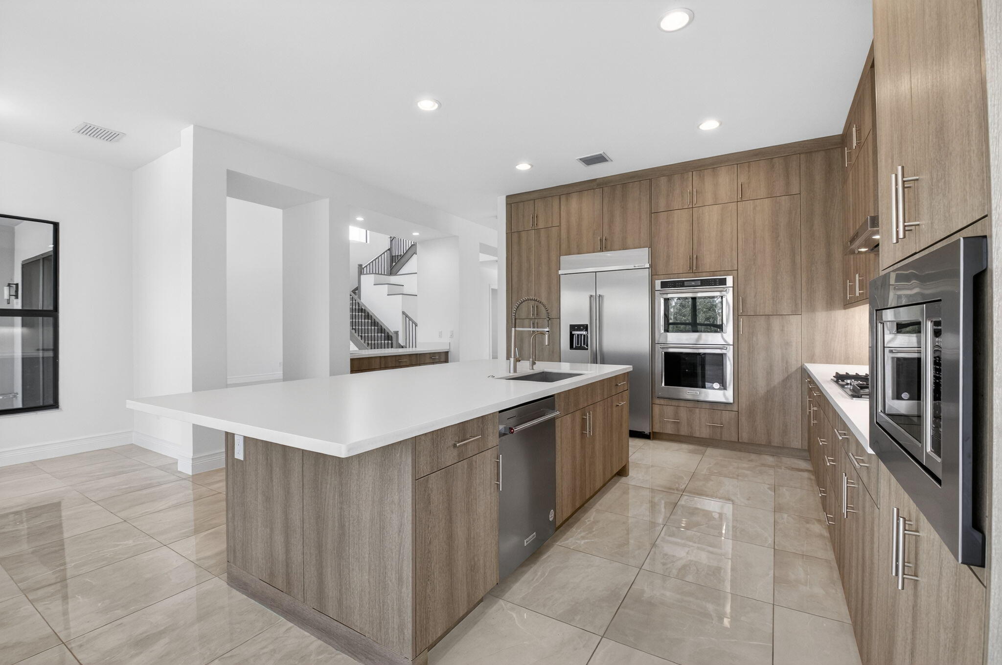 9087 Chauvet Way Boca Raton, FL 33496 - Photo 29 of 78 a large kitchen with stainless steel appliances a sink a counter top space cabinets and a stove