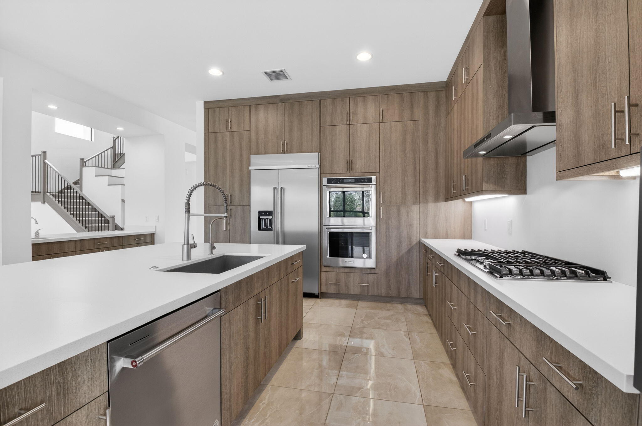 9087 Chauvet Way Boca Raton, FL 33496 - Photo 30 of 78 a kitchen with kitchen island stainless steel appliances a sink stove and cabinets