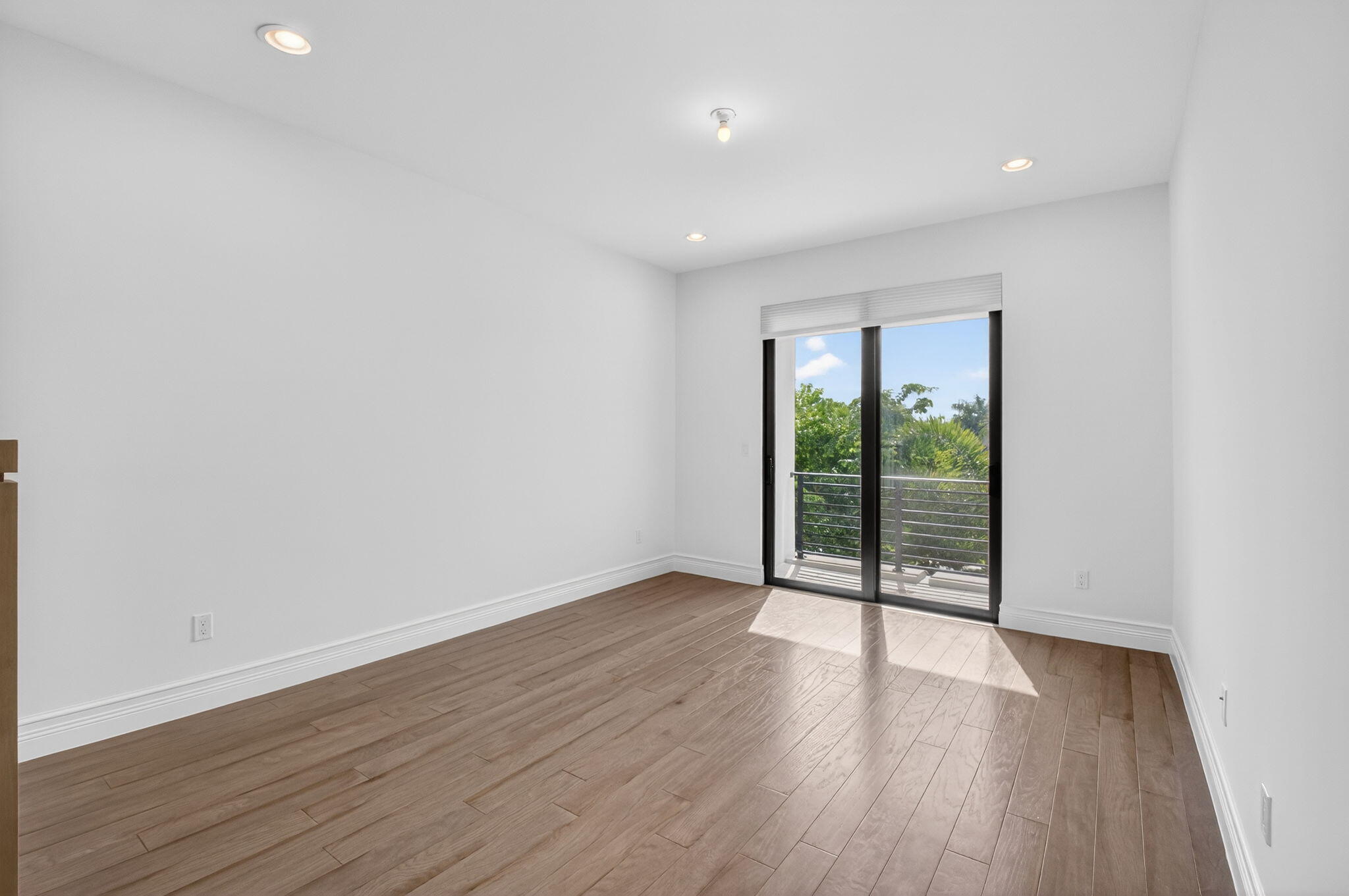 9087 Chauvet Way Boca Raton, FL 33496 - Photo 38 of 78 a view of an empty room with wooden floor and a window