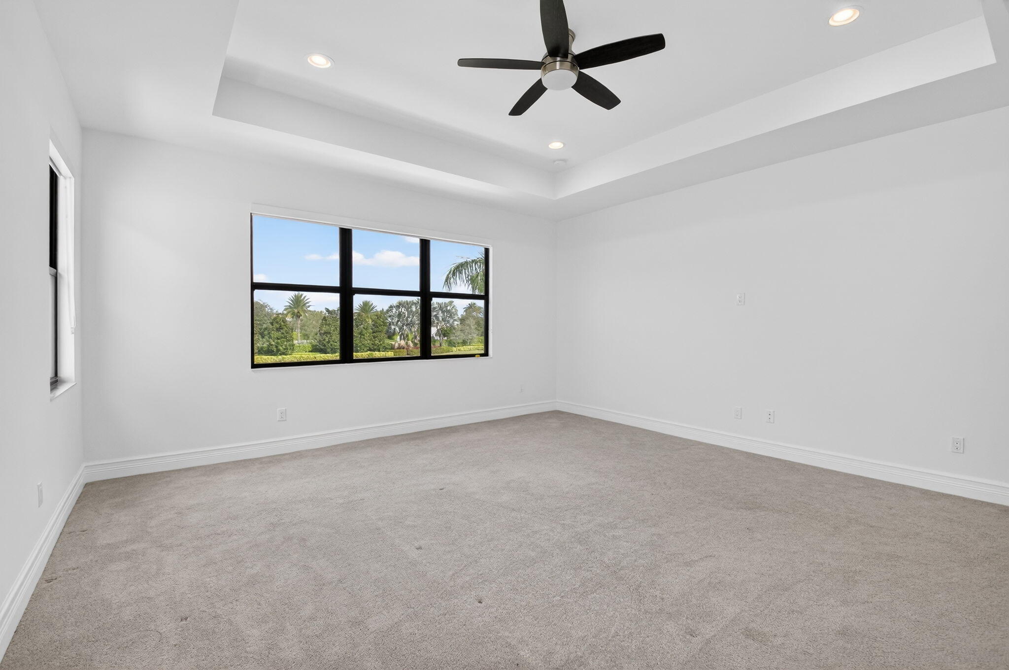 9087 Chauvet Way Boca Raton, FL 33496 - Photo 40 of 78 an empty room with windows and ceiling fan