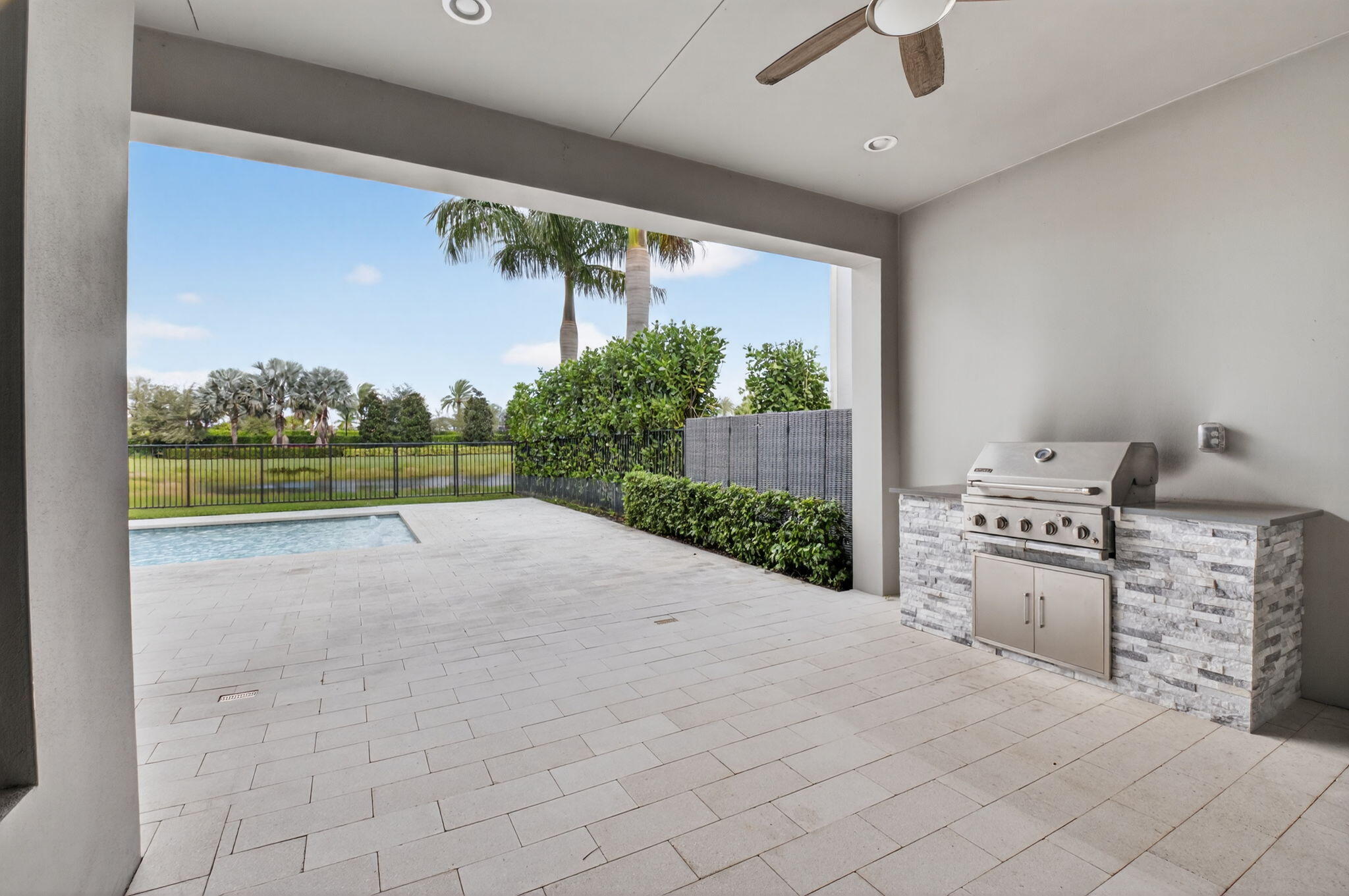 9087 Chauvet Way Boca Raton, FL 33496 - Photo 53 of 78 a view of a kitchen with a sink and a fireplace in a room