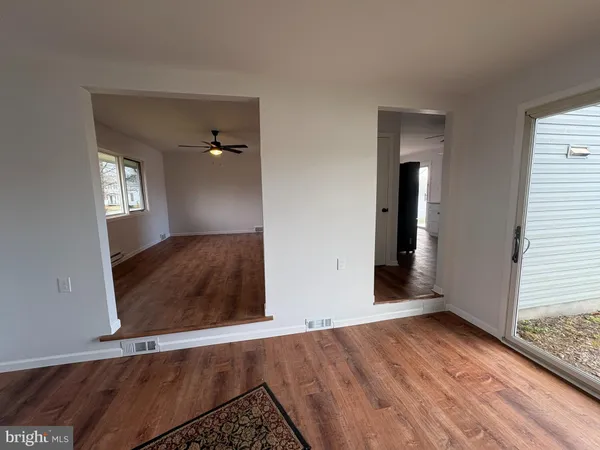 wooden floor in an empty room with a window