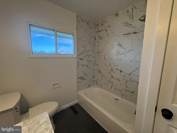 a bathroom with a bathtub and shower