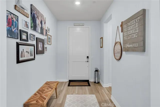 a kitchen with stainless steel appliances kitchen island granite countertop a sink a stove and a refrigerator