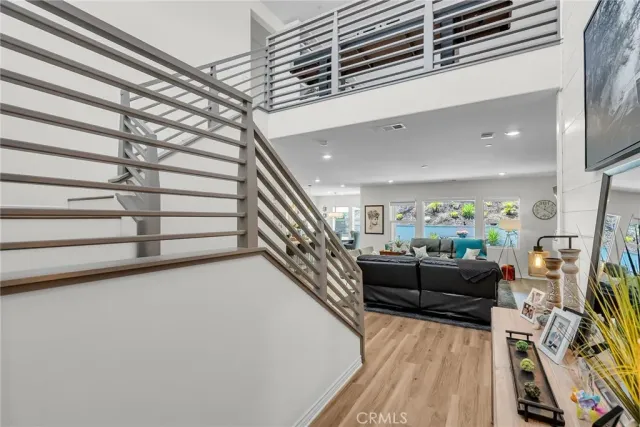 a kitchen with stainless steel appliances a sink a stove and a wooden floors