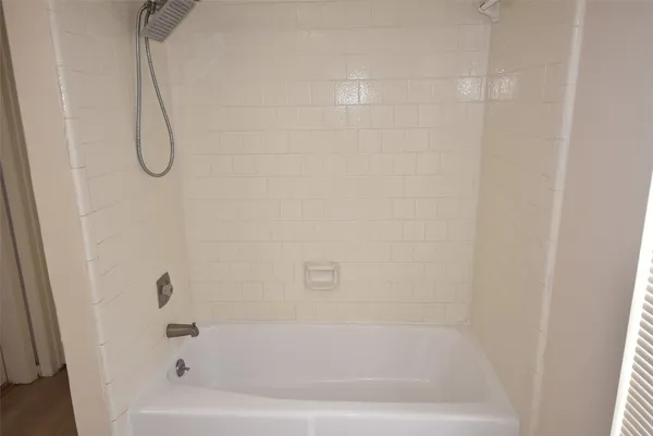 a bathroom with a bath tub and a shower