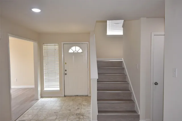 a view of entryway with wooden floor and stairs