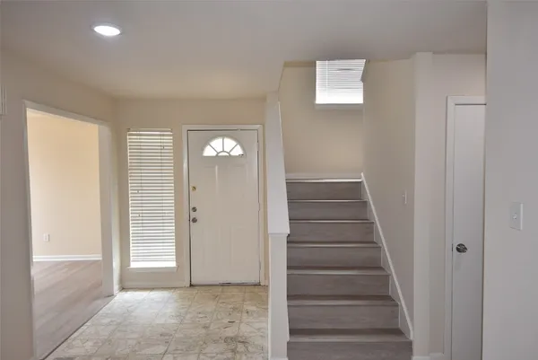 a view of entryway with wooden floor and stairs