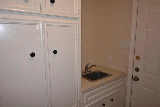 a bathroom with a sink and cabinets