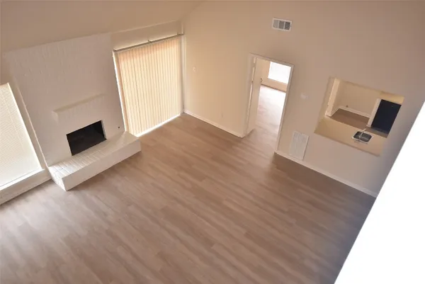wooden floor in an empty room with a fireplace