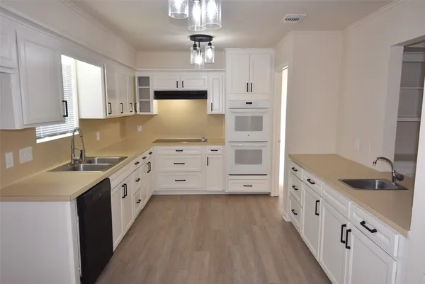 a kitchen with stainless steel appliances a sink stove and cabinets