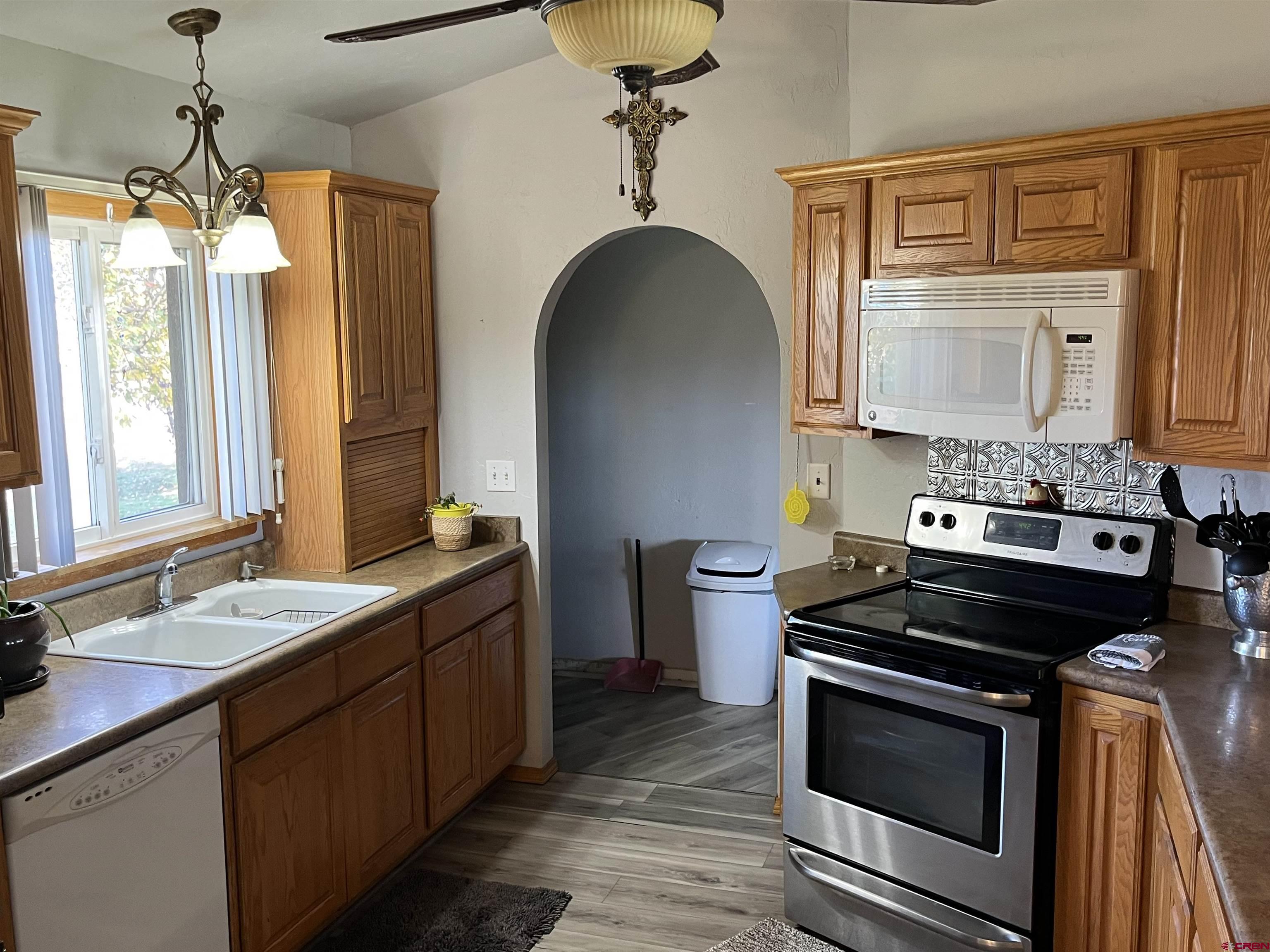 16400 6630 Road Montrose, CO 81401 - Photo 12 of 27 a kitchen with a sink stove and cabinets