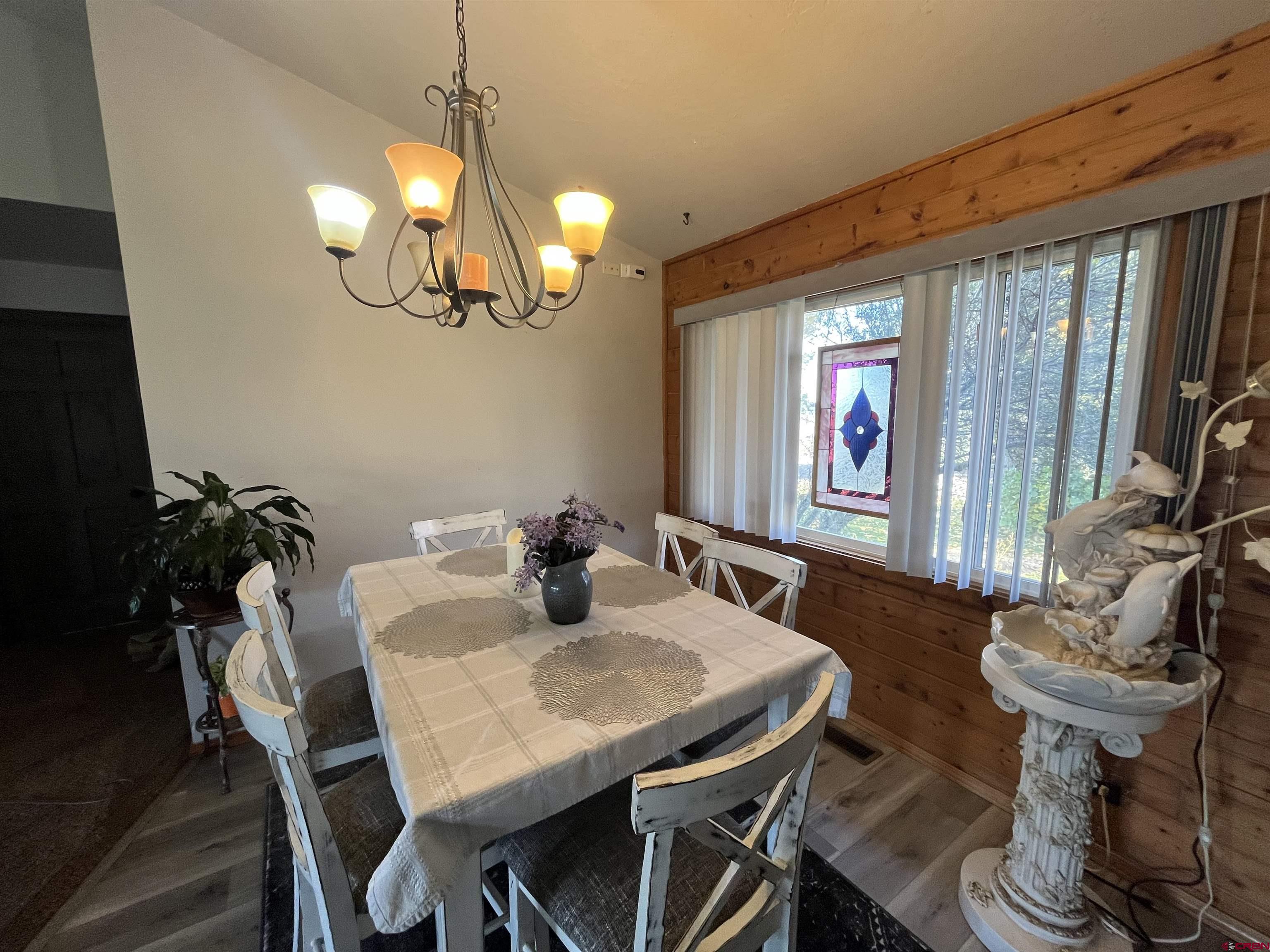 16400 6630 Road Montrose, CO 81401 - Photo 13 of 27 a view of a dining room with furniture window and wooden floor
