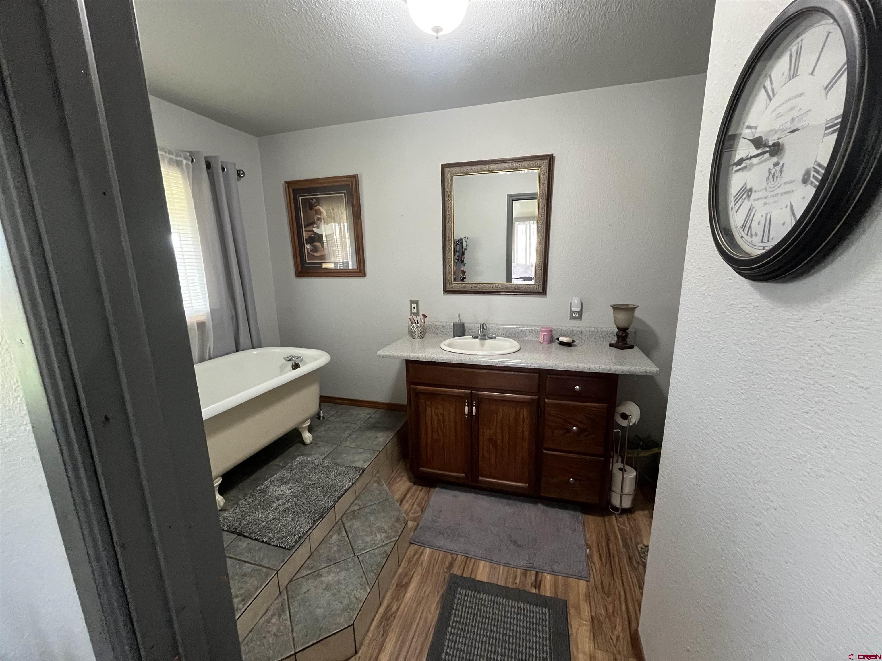 16400 6630 Road Montrose, CO 81401 - Photo 17 of 27 a bathroom with a toilet a sink and a mirror