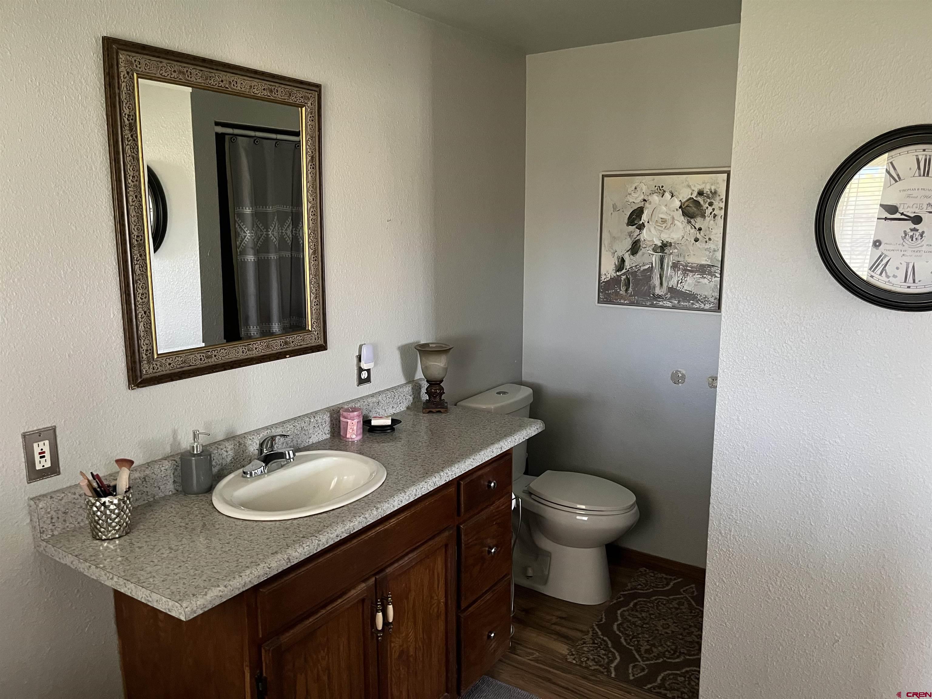 16400 6630 Road Montrose, CO 81401 - Photo 19 of 27 a bathroom with a toilet sink and mirror