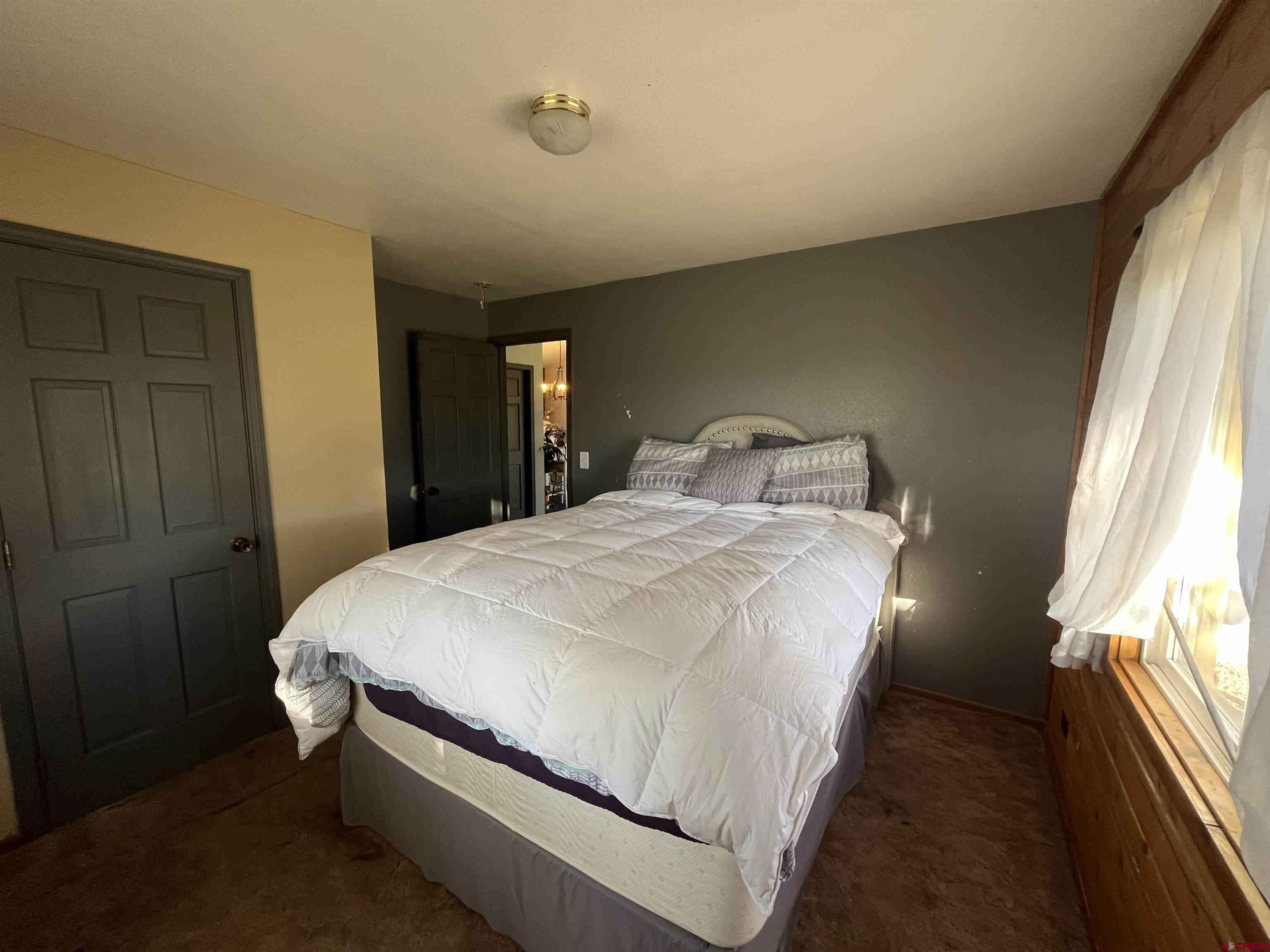 16400 6630 Road Montrose, CO 81401 - Photo 22 of 27 a bedroom with a bed and a window