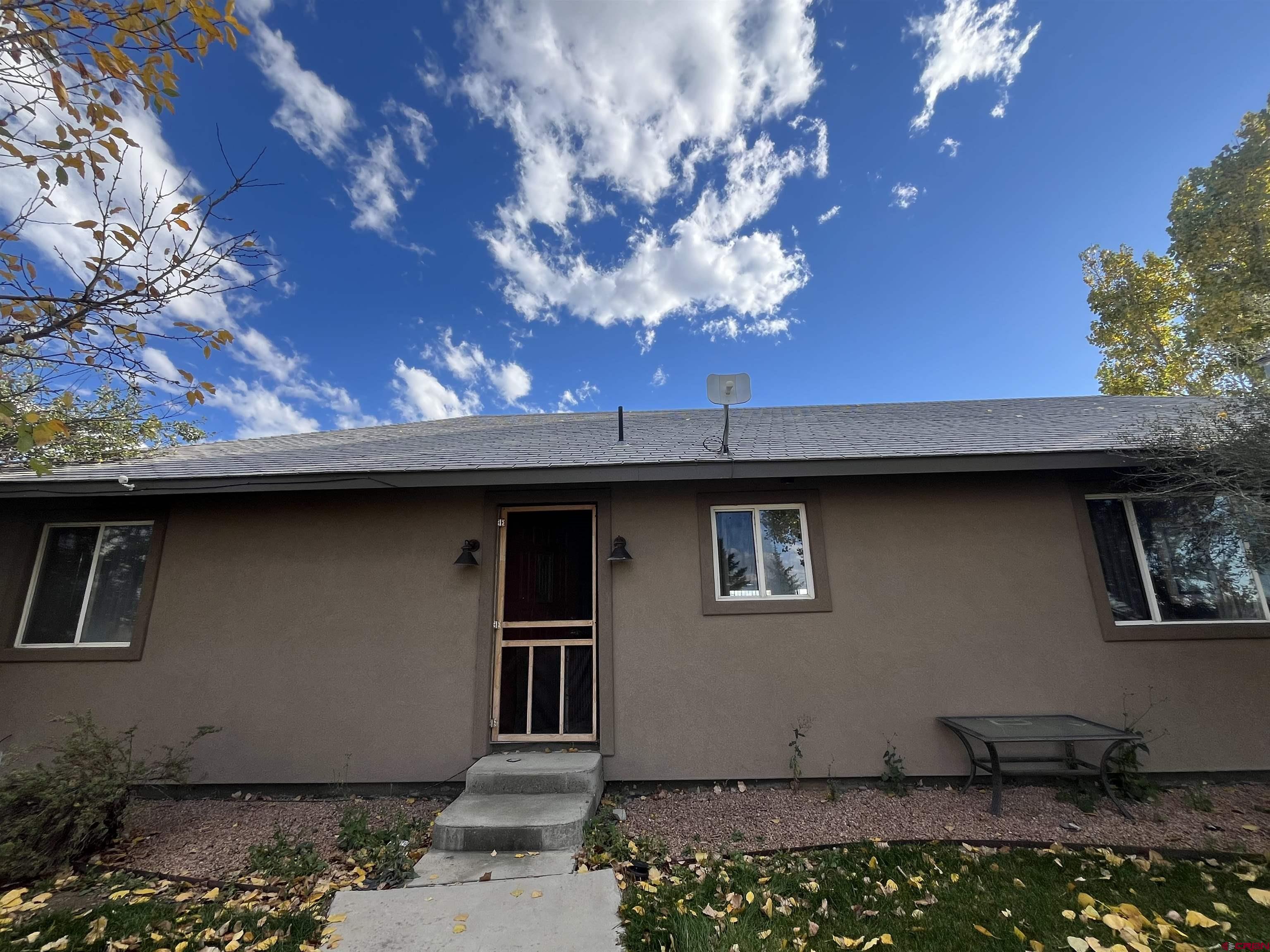 16400 6630 Road Montrose, CO 81401 - Photo 3 of 27 a front view of a house with a yard