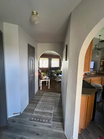 a view of a livingroom with wooden floor and furniture