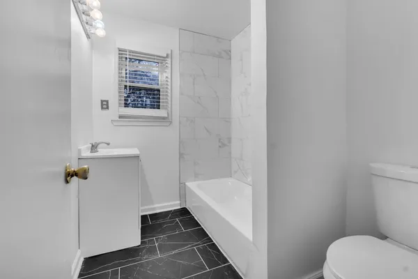 a bathroom with a bathtub sink and toilet