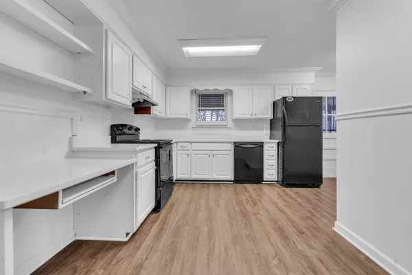 a kitchen with stainless steel appliances a refrigerator sink and cabinets