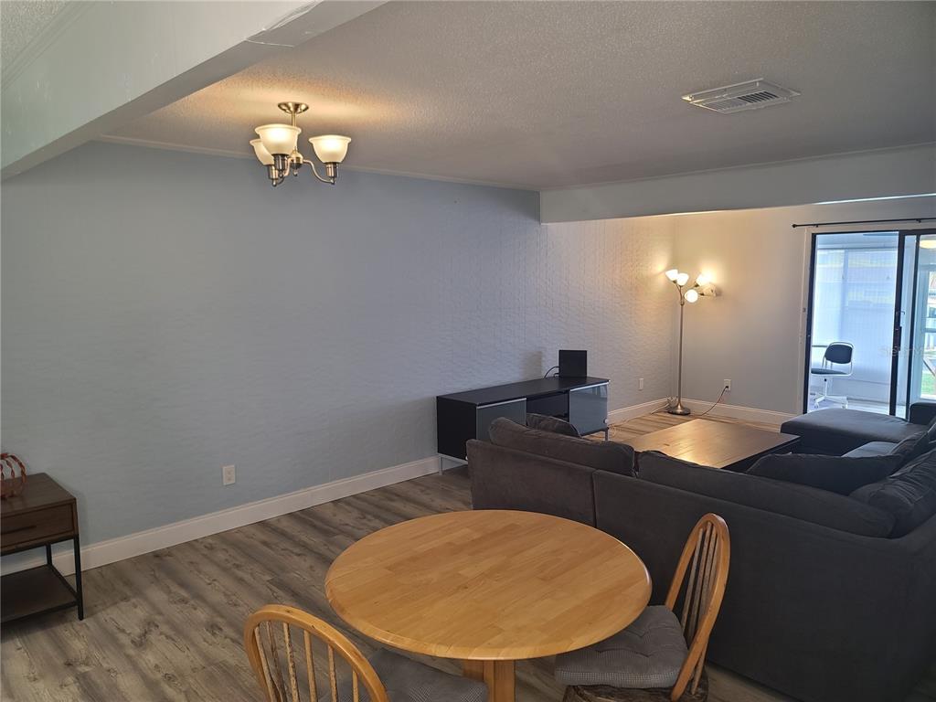 11001 Southeast Sunset Harbor Road, Unit C27 Summerfield, FL 34491 - Photo 13 of 53 a bathroom with a granite countertop sink a mirror and lamp