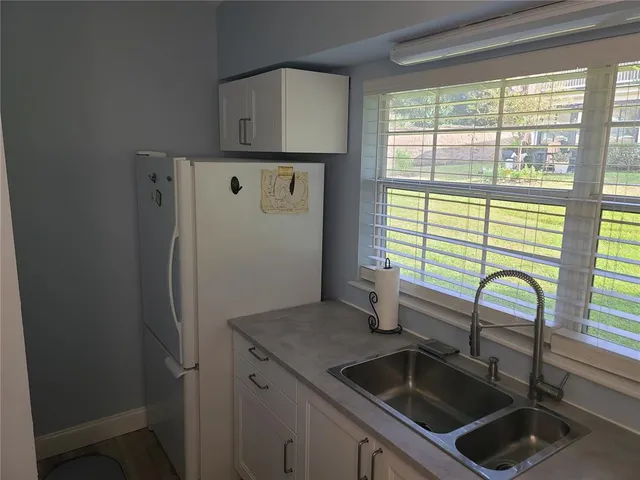 a kitchen with a sink and a refrigerator