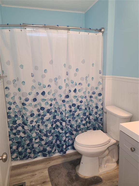 11001 Southeast Sunset Harbor Road, Unit C27 Summerfield, FL 34491 - Photo 21 of 53 a bathroom with a toilet and a shower curtain