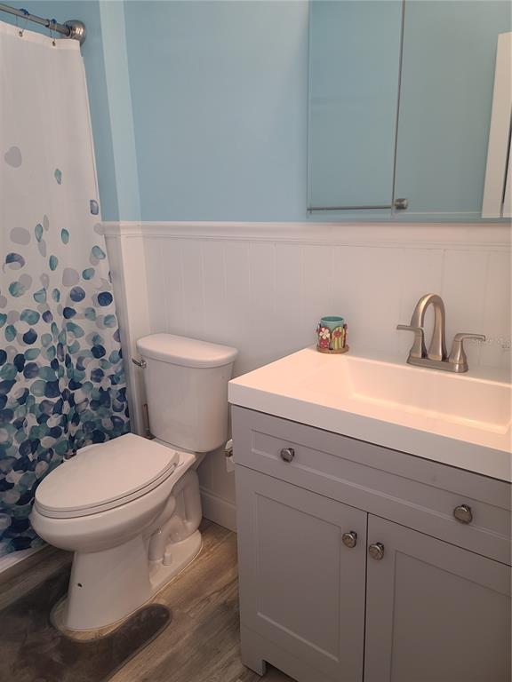 11001 Southeast Sunset Harbor Road, Unit C27 Summerfield, FL 34491 - Photo 22 of 53 a bathroom with a toilet sink and mirror