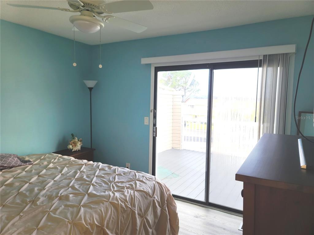11001 Southeast Sunset Harbor Road, Unit C27 Summerfield, FL 34491 - Photo 24 of 53 a bedroom with a bed and a large window