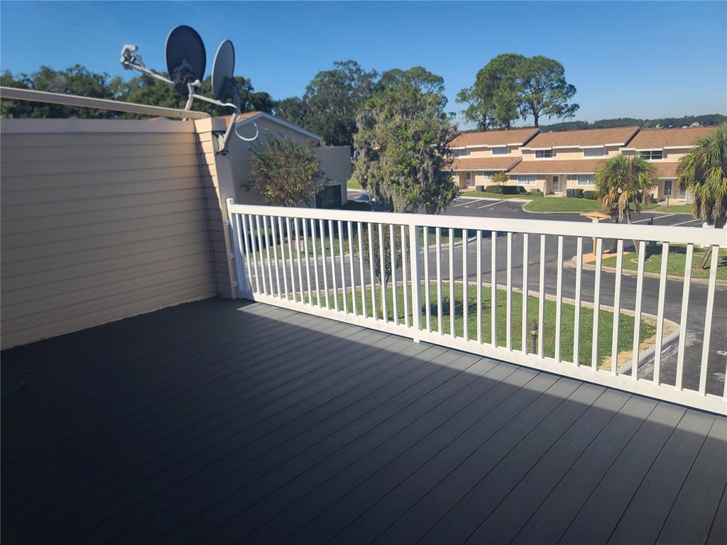 11001 Southeast Sunset Harbor Road, Unit C27 Summerfield, FL 34491 - Photo 25 of 53 a view of a balcony with two chairs