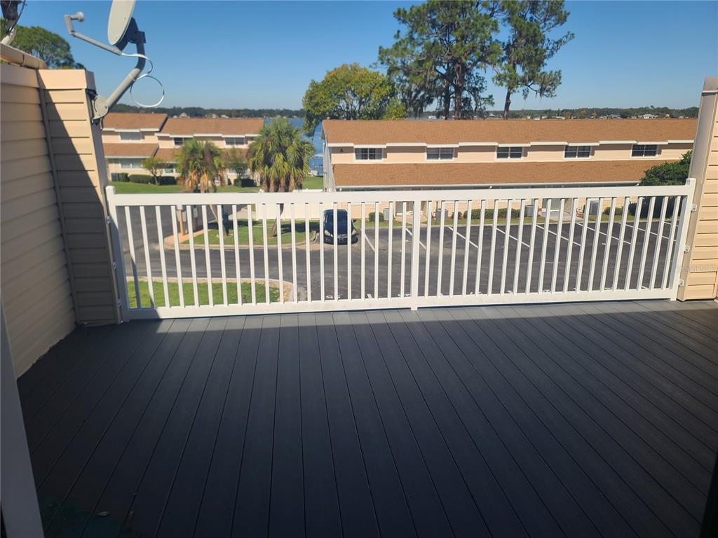 11001 Southeast Sunset Harbor Road, Unit C27 Summerfield, FL 34491 - Photo 27 of 53 a view of a wooden deck