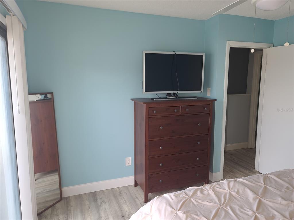 11001 Southeast Sunset Harbor Road, Unit C27 Summerfield, FL 34491 - Photo 31 of 53 a bedroom with a bed and a television