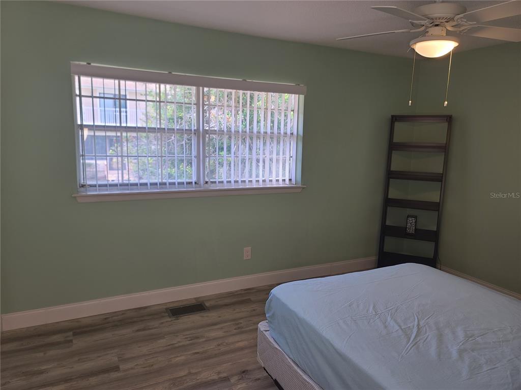 11001 Southeast Sunset Harbor Road, Unit C27 Summerfield, FL 34491 - Photo 33 of 53 a bedroom with a bed and a window