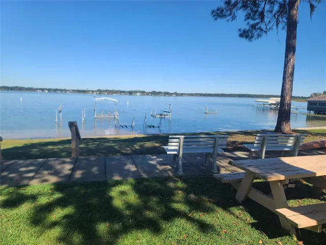 a backyard of a house with table and chairs
