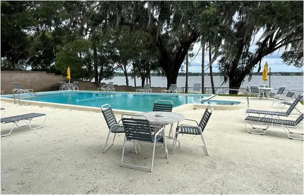 11001 Southeast Sunset Harbor Road, Unit C27 Summerfield, FL 34491 - Photo 47 of 53 a view of a backyard with sitting area
