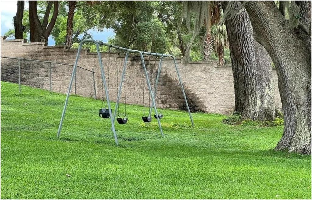 11001 Southeast Sunset Harbor Road, Unit C27 Summerfield, FL 34491 - Photo 49 of 53 a view of a park with a bench