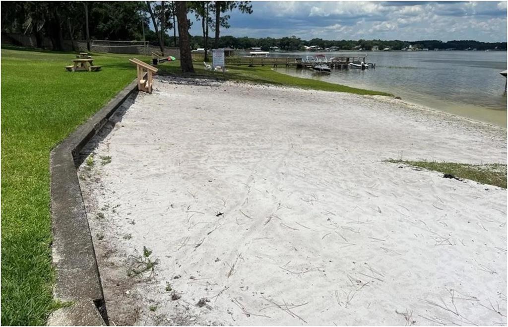 11001 Southeast Sunset Harbor Road, Unit C27 Summerfield, FL 34491 - Photo 51 of 53 a view of a lake with a yard and a building