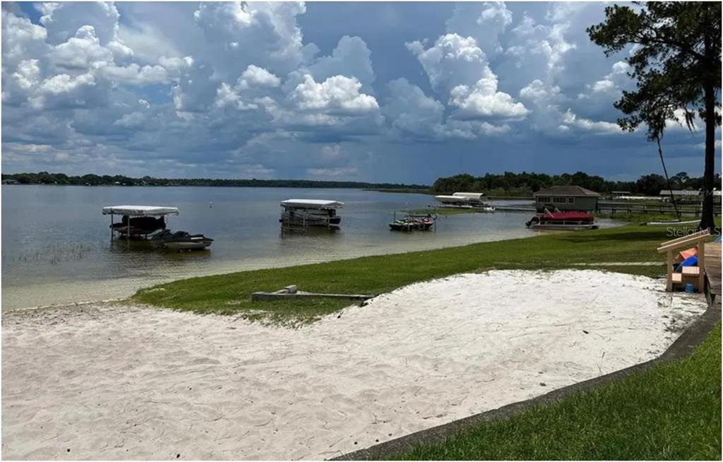 11001 Southeast Sunset Harbor Road, Unit C27 Summerfield, FL 34491 - Photo 53 of 53 a view of a swimming pool with a yard