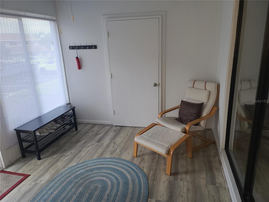 11001 Southeast Sunset Harbor Road, Unit C27 Summerfield, FL 34491 - Photo 8 of 53 a bedroom with a bed and wooden floor