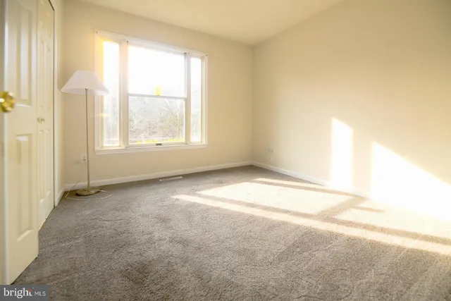 a view of an empty room with a fan