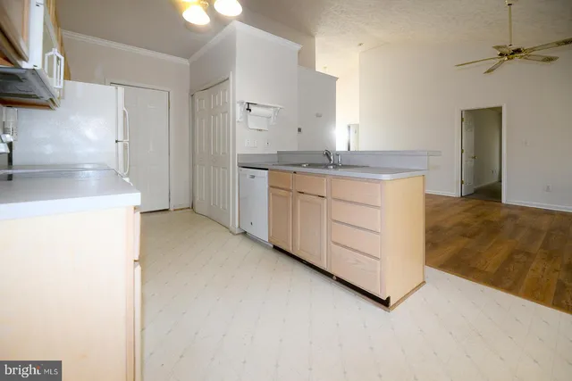 a kitchen with a refrigerator sink stove and cabinets