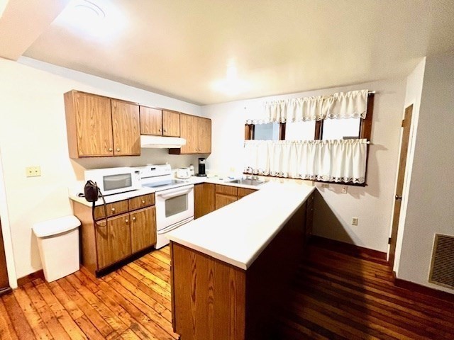 267 Locust Street, Unit 2G Northampton, MA 01062 - Photo 7 of 24 a kitchen with granite countertop a sink cabinets stainless steel appliances and a window