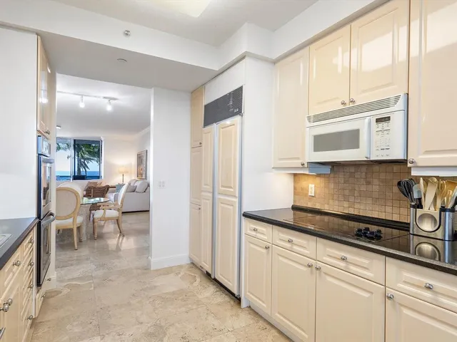 a kitchen with stainless steel appliances granite countertop a refrigerator and cabinets