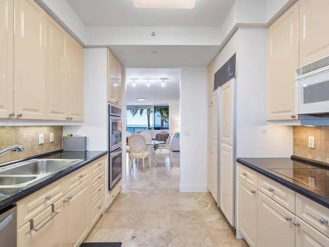 a large white kitchen with a large window