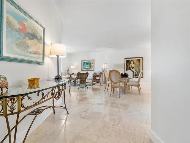 a view of a livingroom with furniture and a painting on the wall